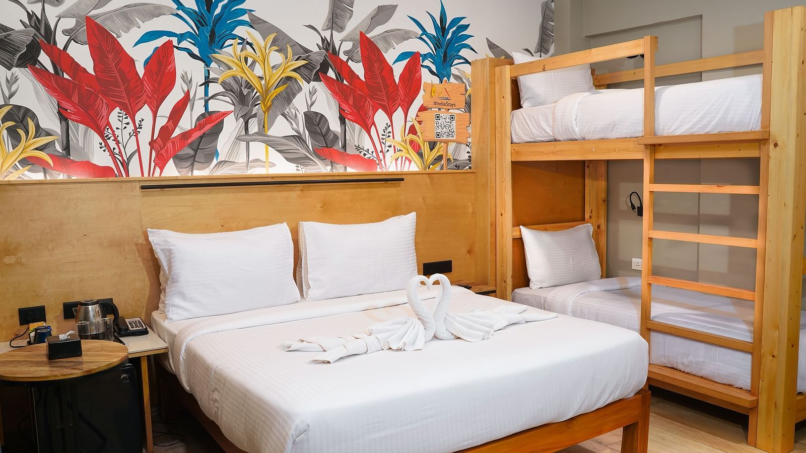 A large bed next to bunk beds in Urban Corner Family Room at Indie Stays Resort, Goa.